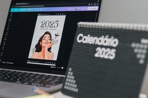 An organised desk with a 2025 calendar and a laptop