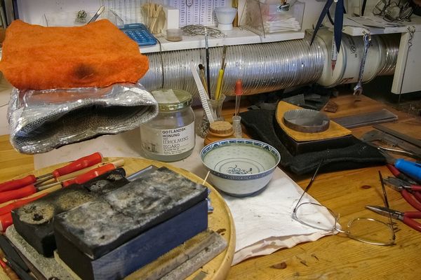 Hand tools laid out in a jewellery workshop