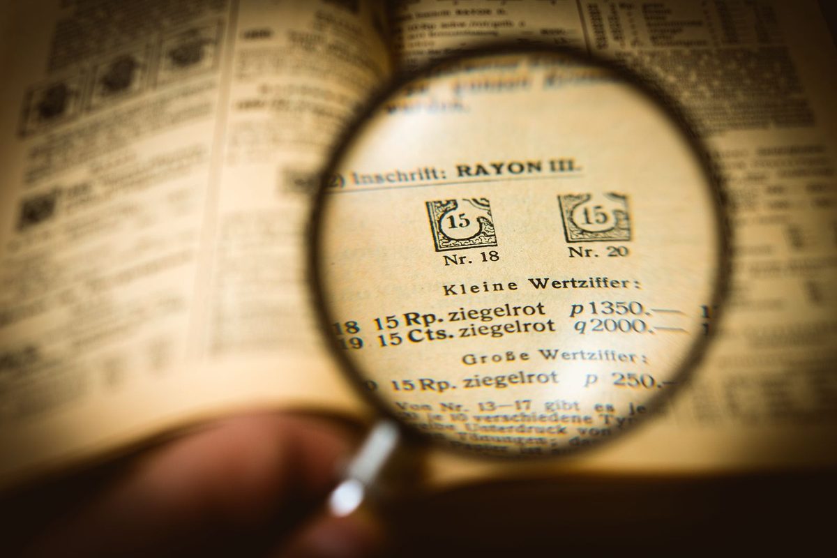 A magnifying glass held over the text of an open book page